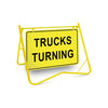 Trucks Turning (Text), 900 x 600mm Metal, Class 1 Reflective, Swing Stand